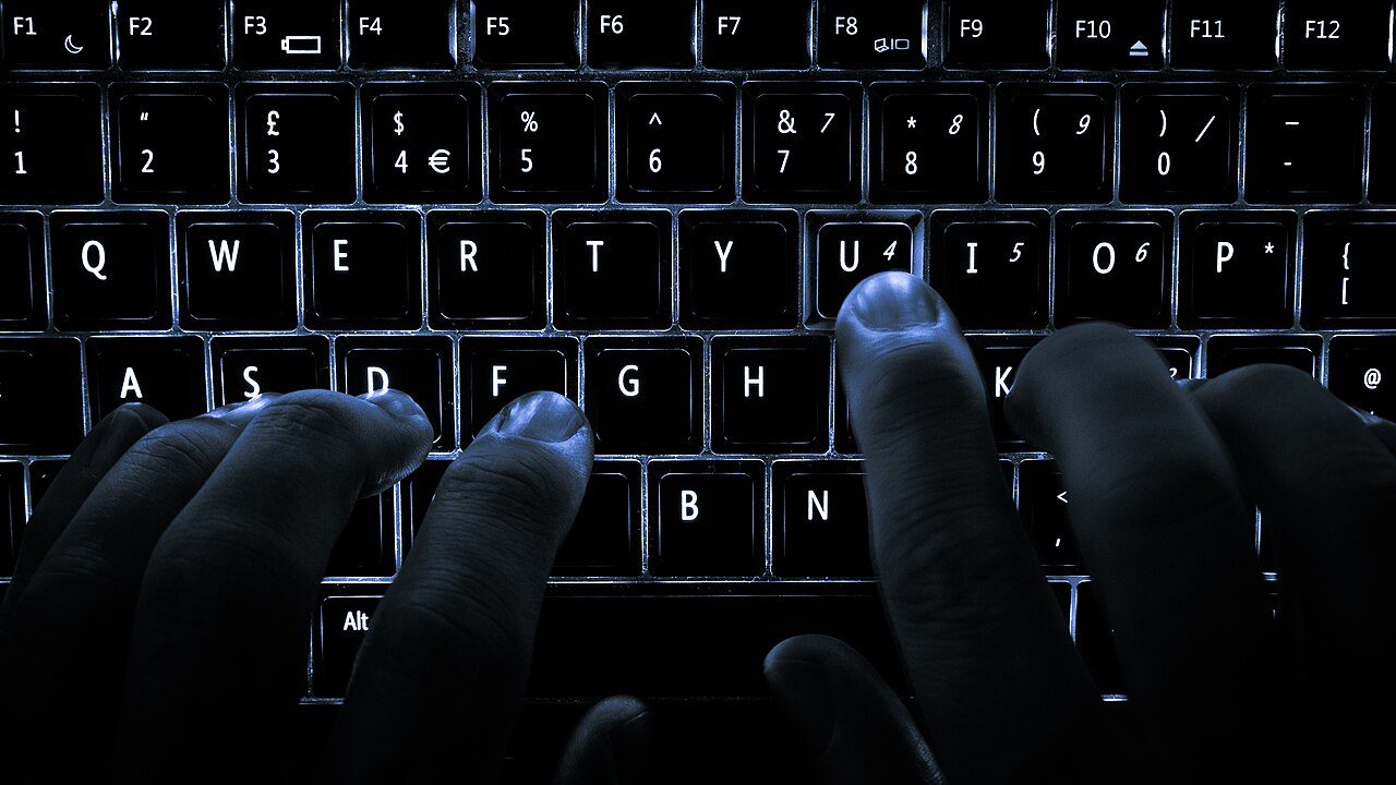 A player's hands resting on a backlit keyboard, the point at which a large asset library is finally used